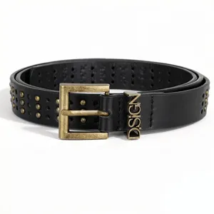 Close-up of black leather punk belt with gold rivets and D.SIGN metal buckle.