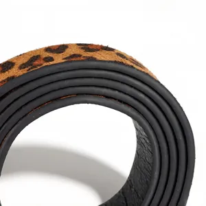 Close-up detail of a women's leopard print belt showing the high-quality black oil edge finish