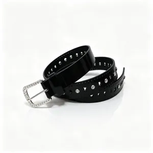 Detailed view of black patent leather belt with heart cutouts and rhinestones