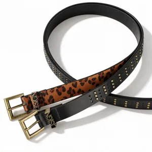 Close-up detail of punk studded belts with leopard print and D.SIGN metallic buckles
