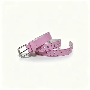 Close-up of pink glossy women's belt with rhinestone buckle and heart shaped cutouts