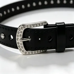 Close-up of black leather belt with rhinestone-encrusted silver buckle and studs