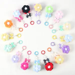 Detailed arrangement of colorful beaded flower pom-pom pendants and charms.