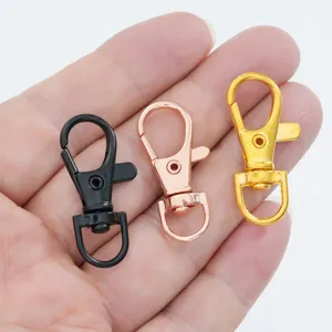 Close-up of three alloy lobster clasps in black, rose gold, and gold colors
