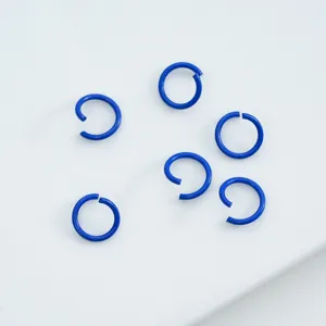 Detail view of vibrant blue painted alloy open jump rings for DIY jewelry craft