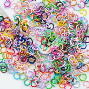 Detailed macro view of colorful painted alloy open jump rings for DIY jewelry making.