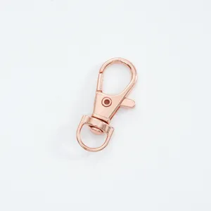 Close-up detail of a rose gold alloy lobster clasp accessory for bags and keychains