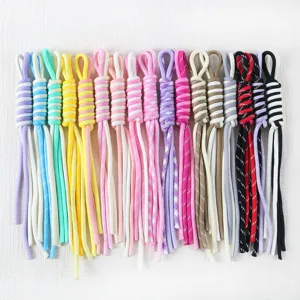 Close-up detail of hand-woven colorful Roman knot lanyards for DIY phone and bag charms.