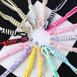 Close-up of colorful handmade woven Roman knot lanyards for phones, keys, and accessories.