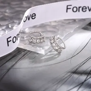 Close-up view of silver-tone double-layer twisted ear cuffs with sparkling zircons