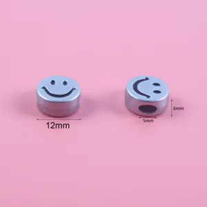 Detailed view of silver smiley face acrylic beads with 12mm and 6mm sizing labels