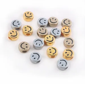 Macro view of metallic gold and silver smiley face acrylic beads for DIY jewelry making