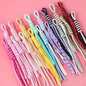 Close-up of colorful hand-woven Roman knot lanyards for DIY phone and bag charms
