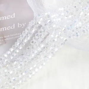 Detailed macro view of 4mm AB iridescent crystal bicone beads with brilliant sparkle
