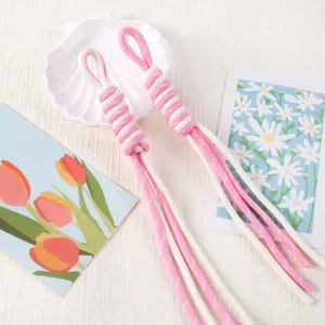 Close-up of pink and white hand-woven Roman knot lanyards for phone and DIY accessories