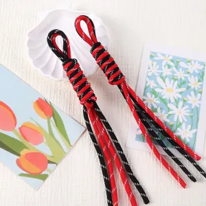 Detailed view of red and black woven paracord Roman knots for DIY keychains and bags