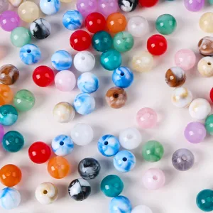 Close-up of mixed colorful marbled acrylic beads for DIY jewelry making material