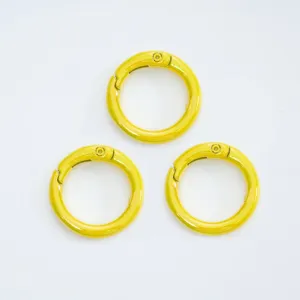 Yellow spring ring snap hook detail showing smooth glossy metal finish for bag and key accessories