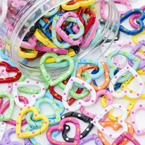 Detailed view of colorful heart-shaped spring clasps, perfect for DIY jewelry and crafts.