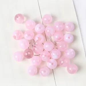 Close-up macro detail of pink cat eye acrylic round beads for DIY jewelry making