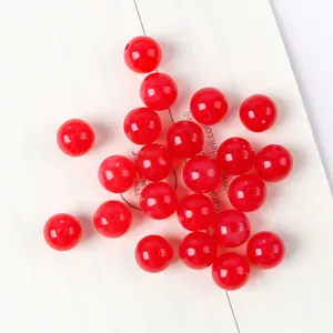 Detailed close-up of bright red acrylic beads with glossy imitation cat eye finish for DIY beading