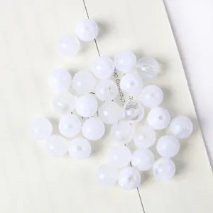 Macro detail of white semi-translucent acrylic cat-eye beads for DIY jewelry