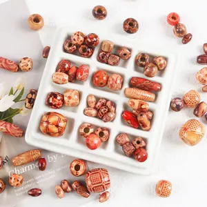 Detail view of natural wooden beads with intricate Chinese style floral and geometric patterns.