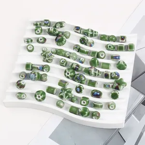 Assorted green ceramic kiln glaze beads in shell and star shapes for DIY jewelry