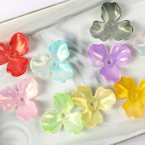 Detailed close-up view of iridescent acrylic magnolia flower petal beads for various DIY crafts