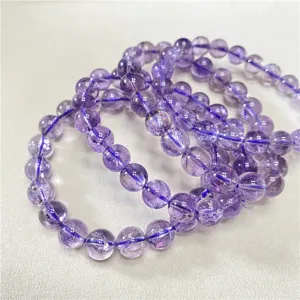 Detailed close-up showing purple crystal beads strung on high-quality elastic jewelry cord