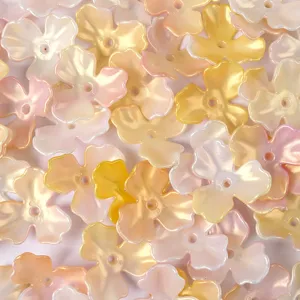 Close-up view of iridescent AB acrylic magnolia flower beads for DIY jewelry making