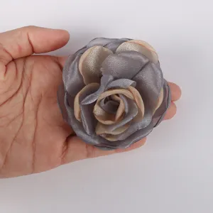 Detailed view of a 7.5cm chiffon burnt-edge rose flower accessory held in a person's hand