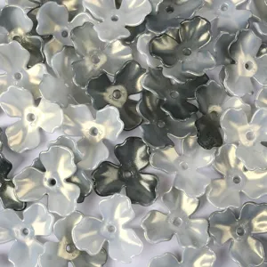 Macro view of iridescent AB acrylic magnolia flower petals for DIY jewelry crafts