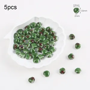 Detail view of 12x10mm green kiln glaze ceramic conch beads for DIY jewelry