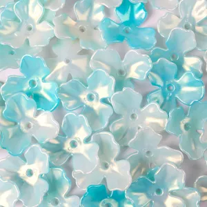 Macro view of iridescent blue and white acrylic flower petal beads for jewelry DIY projects.