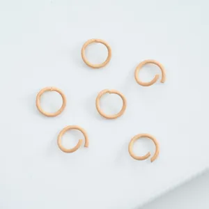 Close-up of light orange enamel jump rings for handmade DIY jewelry making projects