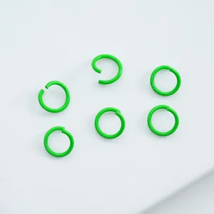 Macro view of bright green painted alloy open jump rings for DIY jewelry making