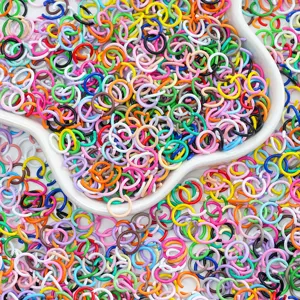 Close-up of assorted colorful painted alloy jump rings for DIY jewelry making