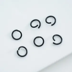 Detailed macro view of black painted alloy open jump rings for DIY jewelry making
