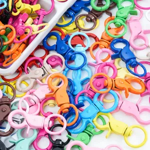Close-up of colorful baked paint lobster clasps, metal keychain spring hooks for DIY jewelry.