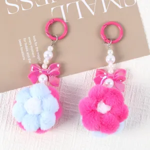 Detailed view of handmade plush flower pendants with beaded chains and bows