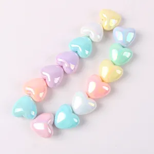 Detailed close-up shot of colorful acrylic AB heart beads, perfect for DIY jewelry making.