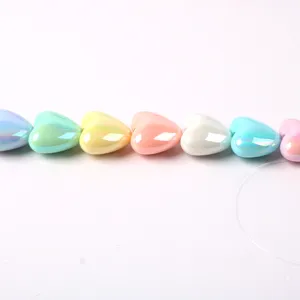 Close-up of colorful iridescent heart acrylic beads detail, perfect for DIY crafts.