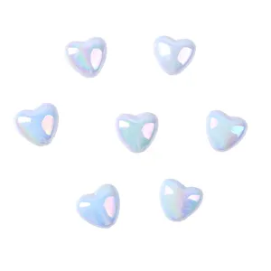 Close-up detail of light blue AB iridescent heart acrylic loose craft beads for DIY.