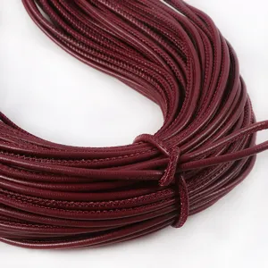 Macro view of 3mm burgundy PU leather cord with exquisite stitching for DIY handbag decor