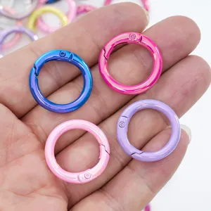 Colorful metal spring rings close-up, vibrant plating snap hooks for DIY jewelry and keychains.