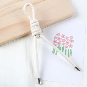 Close-up detail of white pearl-gloss PU leather cord strap with metal tips for DIY bags.