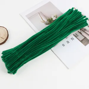 Green pipe cleaners detail shot, plush chenille stems for DIY craft flowers and kids handmade art.