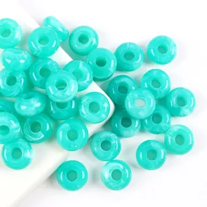 Turquoise acrylic large hole donut beads, close-up view of DIY craft jewelry accessories.