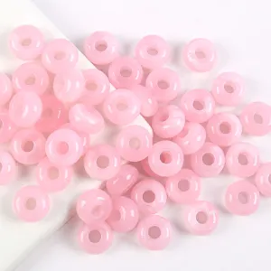 Close-up detail of pink acrylic large hole round beads, perfect for DIY jewelry craft making.